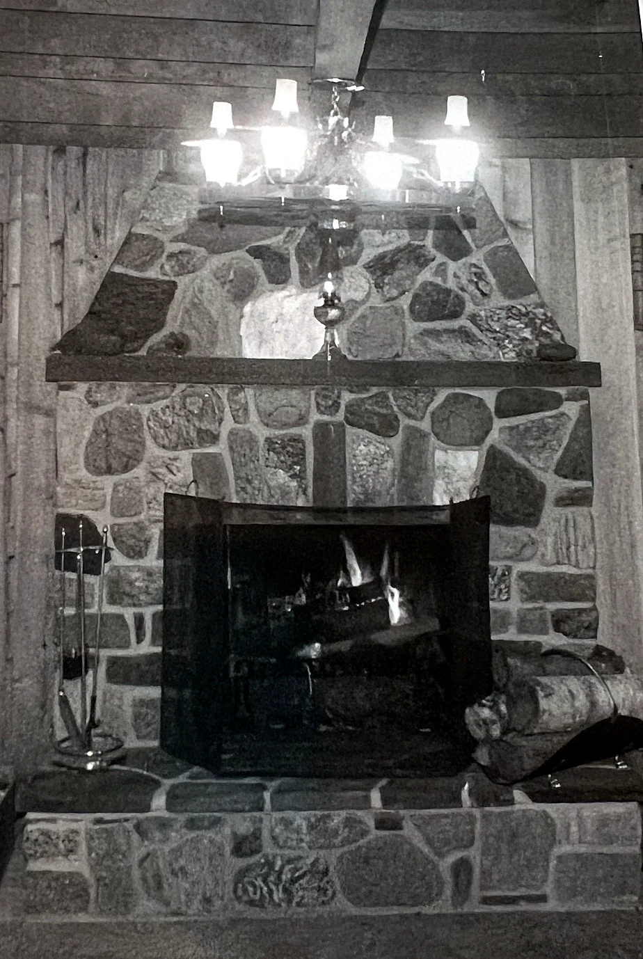 The fireplace with the original wagon-wheel lights — very 1970s, and not very bright. They went as part of the 2013–14 renovation. That reno…